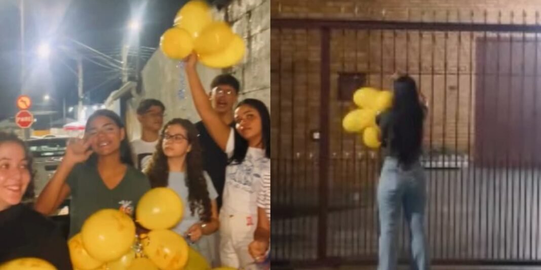 Balão com mensagem 'Jesus te ama' preso em portão de residência em Taubaté ao amanhecer.