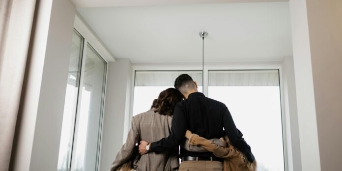 Família unida experimenta a paz após transição para a fé cristã Família reunida e sorrindo em um sofá, simbolizando restauração e esperança.