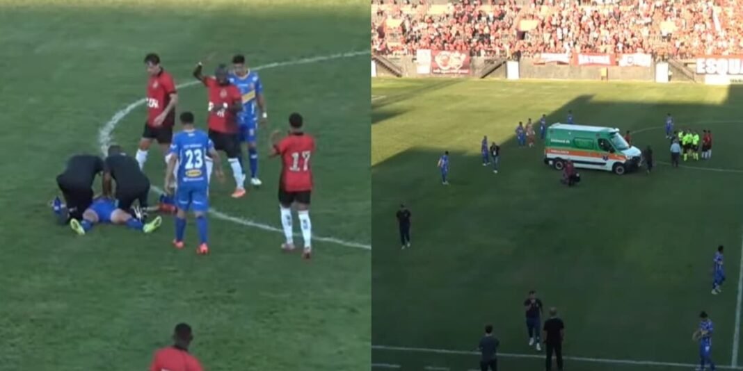 Árbitro de futebol de joelhos em campo, orando por um jogador contundido.