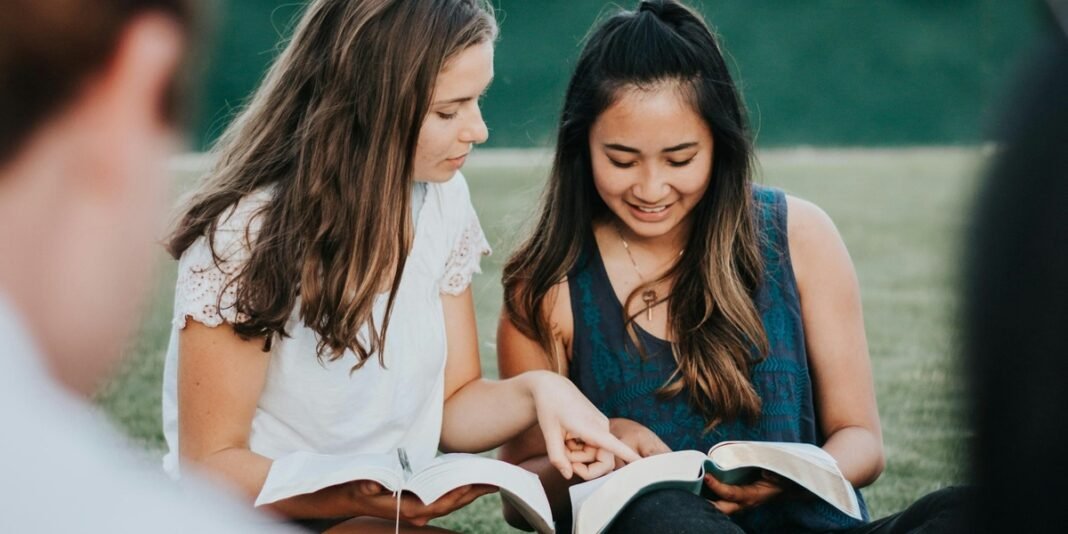 Grupo de pessoas engajadas em atividade de discipulado em ambiente de aprendizado.