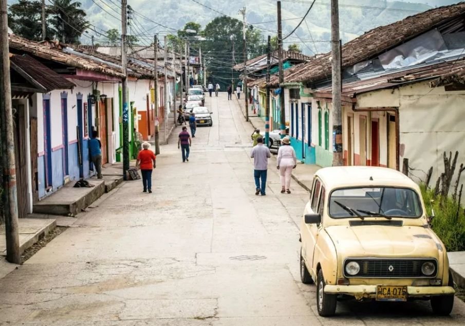 Pastor colombiano em frente a sua igreja, com expressão de preocupação.