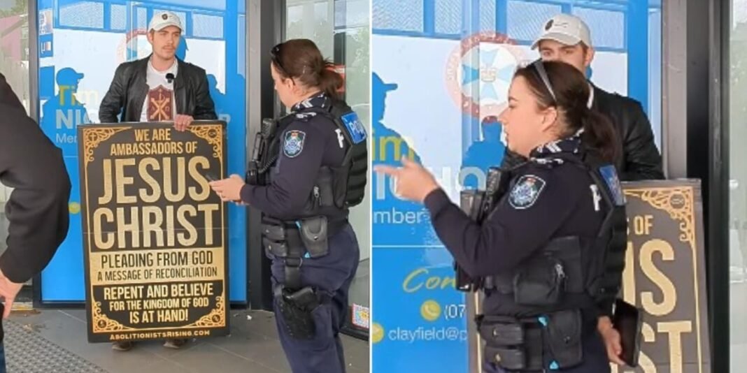 Evangelista Jarryn Emms sendo confrontado por uma policial durante protesto contra o aborto na Austrália.
