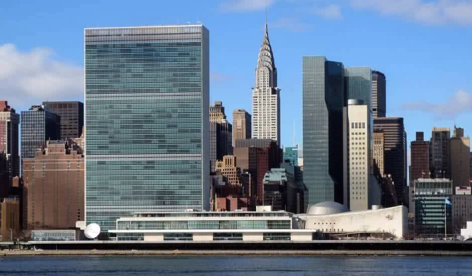 Representantes de países reunidos em uma sala de conferências da ONU discutindo políticas globais.