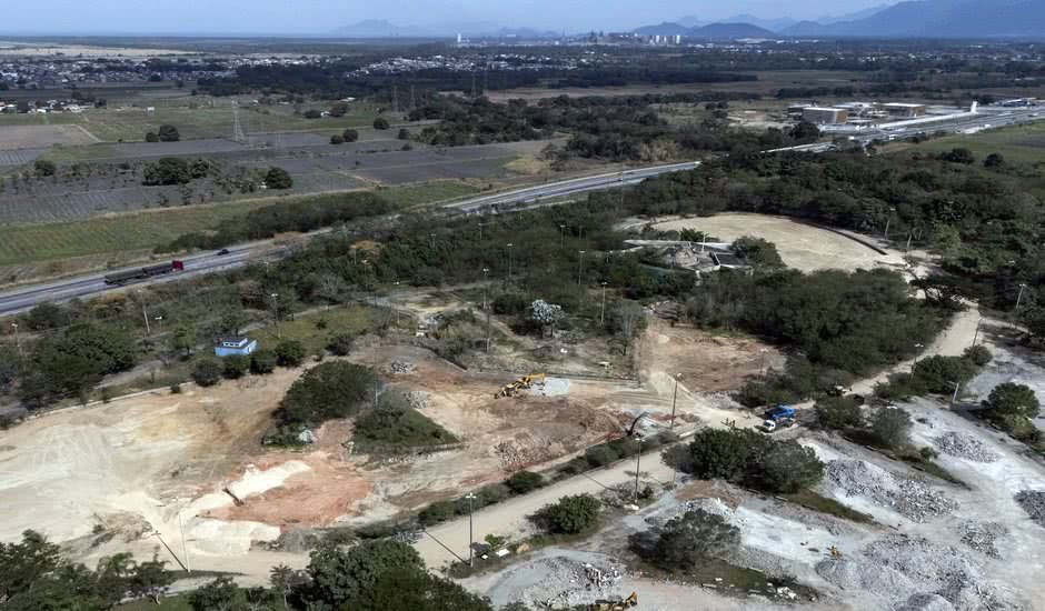 Vista aérea do canteiro de obras do Parque Terra Prometida em Santa Cruz, Rio de Janeiro, evidenciando a escala da construção.