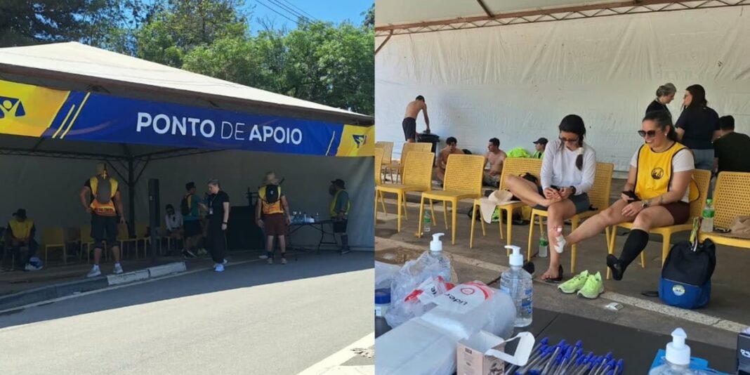 Voluntários da Rede Novo Tempo oferecendo apoio a romeiros em tenda na beira da estrada